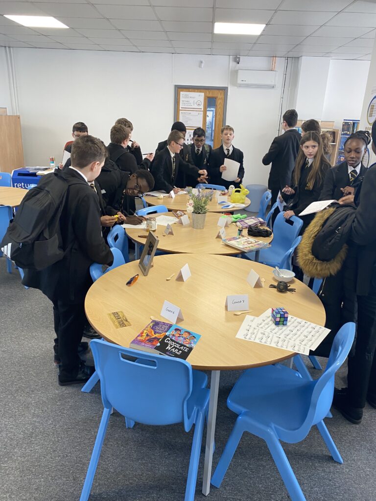 Students stood around a table participating in an activity
