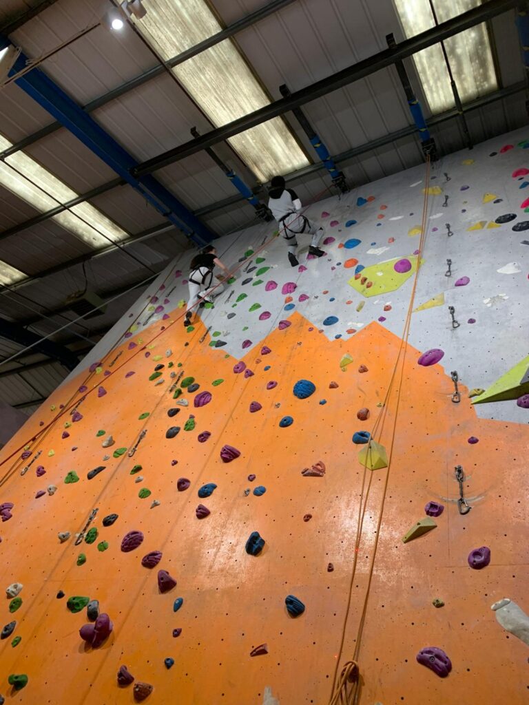 Students on a rock climbing wall