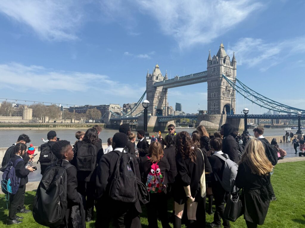 Students on the South Bank looking at Tower Bridge