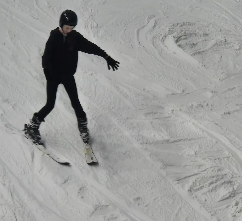 A child going down a ski slope on skis