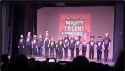 group of student standing on a stage for Bexley talent encore